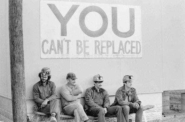 KENTUCKY: COAL MINING, 1979. Coal miners in helmets seated beneath a health-and-safety slogan, Pike County, Kentucky. Photograph by Nan E. Elliot, 1979.  Copyright: xGRANGERx xGRANGERx 0637005