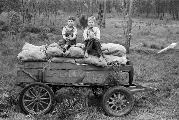 LOUISIANA: FARM BOYS, 1938. Farm boys seated on a cart in Louisiana. Photograph by Russell Lee, October 1936.  Copyright: xGRANGERx xGRANGERx 0637259