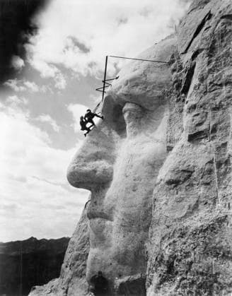 MOUNT RUSHMORE, c1932. American sculptor John Gutzon de la Monthe Borglum (1867-1941), inspecting work on the face of George Washington on Mount Rushmore in South Dakota. Photograph, c1932.  Copyright: xGRANGERx xGRANGERx 0640834