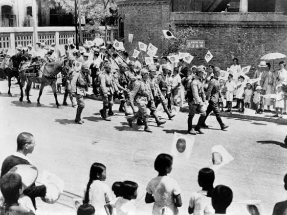 SECOND SINO-JAPANESE WAR. Japanese residents of Beijing waving flags at marching Japanese troops, during the Second Sino-Japanese War. Photograph, 1937.  Copyright: xGRANGERx xGRANGERx 0643845