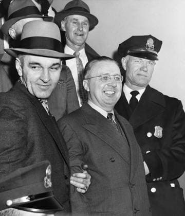 GEORGE METESKY (1903-1994). American electrician and terrorist known as the Mad Bomber for planting bombs throughout New York City in the 1940s and 1950s. Metesky being brought to Waterbury police headquarters for booking. Photograph by Phil Stanziola, 1957.  Copyright: xGRANGERx xGRANGERx 0644341