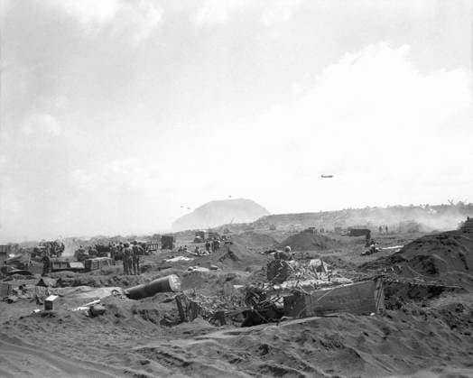 WWII: IWO JIMA, 1945. American Marine forces arrayed across an Iwo Jima beach after the initial amphibious assault; Mount Suribachi is visible in the distance. Photograph from the United States Marine Corps, February 1945.  Copyright: xGRANGERx xGRANGERx 0644865