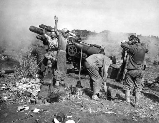 WWII: IWO JIMA, 1945. Marine artillery crew firing a howitzer on an Iwo Jima beach. Photograph from the United States Marine Corps, 1945.  Copyright: xGRANGERx xGRANGERx 0644874