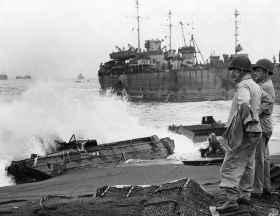 HOLLAND SMITH (1882-1967). American Marine Corps general. Surveying the wreckage of marine landing craft on an Iwo Jima beach during the American assault on the island. Photograph from the United States Marine Corps, February 1945.  Copyright: xGRANGERx xGRANGERx 0644876