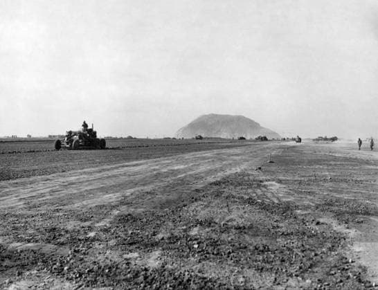 WWII: IWO JIMA, 1945. Motoyama Airfield after its capture by American forces during the Battle of Iwo Jima; Mount Suribachi is visible in the distance. Photograph by Karl Thayer Soule of the United States Marine Corps, 1945.  Copyright: xGRANGERx xGRANGERx 0645024