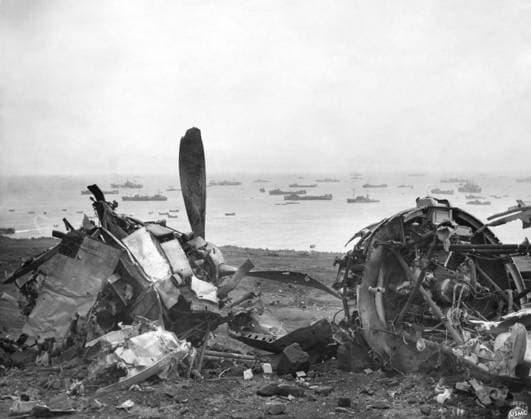 WWII: IWO JIMA, 1945. Wreckage of an airplane on Iwo Jima; part of the United States 5th Fleet is visible in the distance, supporting the Marine assault on the island. Photograph by Karl Thayer Soule, February 1945.  Copyright: xGRANGERx xGRANGERx 0645080