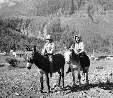 PIONEER CHILDREN, c1901. Going to School. Two schoolchildren riding mules in the American West. Photograph by William Henry Jackson, c1901.  Copyright: xGRANGERx xGRANGERx 0650432