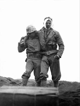 WWII: IWO JIMA, 1945. A United States marine supporting a comrade wounded by mortar fire during the Battle of Iwo Jima. Photograph by Karl Thayer Soule, 1945.  Copyright: xGRANGERx xGRANGERx 0651445
