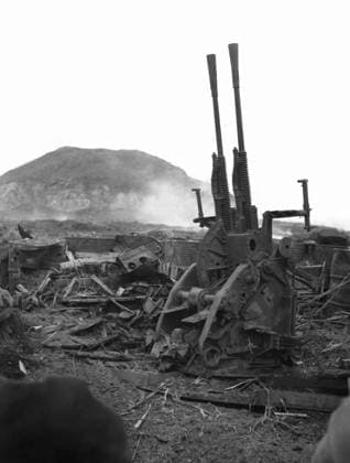 WWII: IWO JIMA, 1945. The remnants of a Japanese anti-aircraft emplacement destroyed during the Battle of Iwo Jima; Mount Suribachi is visible in the distance. Photograph by Karl Thayer Soule, 1945.  Copyright: xGRANGERx xGRANGERx 0651446