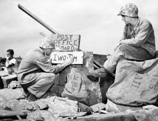 WWII: IWO JIMA, 1945. Sergeant B.D. Bryant paints a sign for a United States Marine Fourth Division post office on Iwo Jima following the American invasion of the island; Corporal Kenneth E. Hales looks on. Photograph by Karl Thayer Soule, 1945.  Copyright: xGRANGERx xGRANGERx 0651449