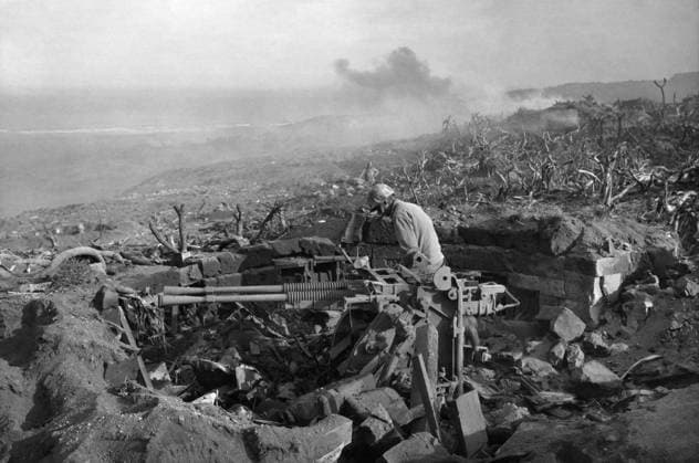 WWII: IWO JIMA, 1945. United States marine inspecting a captured Japanese anti-aircraft emplacement during the Battle of Iwo Jima. Photograph by Karl Thayer Soule, 1945.  Copyright: xGRANGERx xGRANGERx 0651515