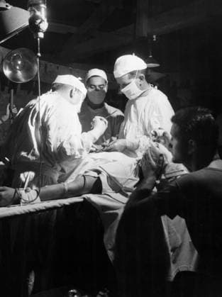 WWII: IWO JIMA, 1945. United States Navy doctors removing shrapnel from the abdomen of a marine at the Fourth Marine Division evacuation hospital during the Battle of Iwo Jima. Photograph by Karl Thayer Soule, 1945.  Copyright: xGRANGERx xGRANGERx 0651634