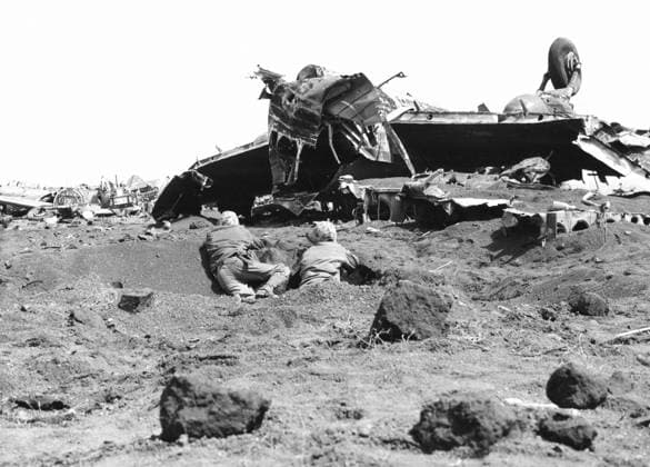WWII: IWO JIMA, 1945. United States marines firing on Japanese snipers amidst the wreckage of planes on Motoyama Airfield during the Battle of Iwo Jima. Photograph by Karl Thayer Soule, February 1945.  Copyright: xGRANGERx xGRANGERx 0651637
