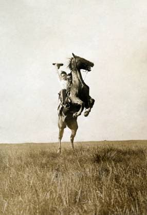 ERWIN E. SMITH (1886-1947). American cowboy photographer. Photographed riding a bucking bronco on the open range of Texas, June 1909.  Copyright: xGRANGERx xGRANGERx 1031615