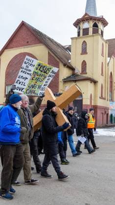 March 29, 2024, Edmonton, Canada: Participant carry a wooden cross as thousands of devotees follow in the Way of the Cross procession through downtown Edmonton. Edmonton Canada - ZUMAs197 20240329_aaa_s197_233 Copyright: xRonxPalmerx