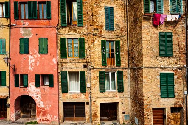 Medieval Italian city of Siena The architecture of the medieval Italian city Siena, old facade, windows with shutters and the spirit of antiquity. Copyright: xZoonar.com gkunax 18738303