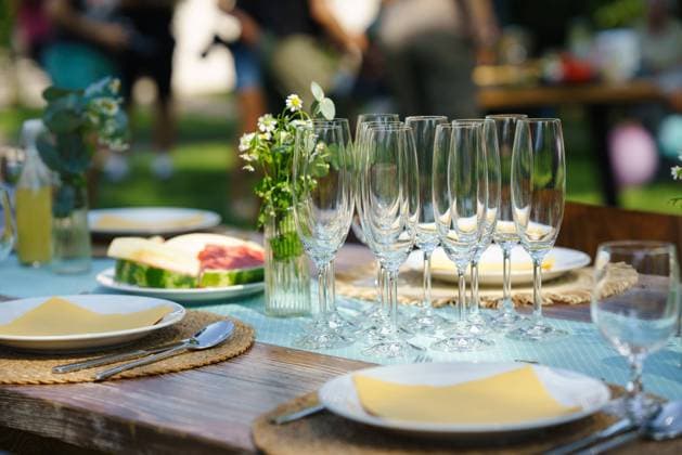 Close up shot of empty wine glasses, cutlery and utensils at summer garden party. Close up shot of empty wine glasses cutlery, utensils at summer garden party. model released