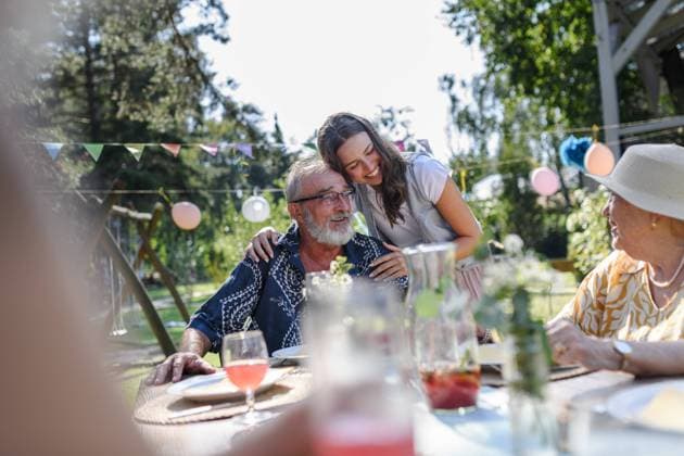 Mature granddaughter talking with grandparents, reunite after a long time. Family gathering at garden party. Mature granddaughter talking with grandparents, reunite after a long time. Family gathering at a garden party. model released