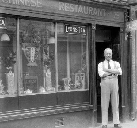 England, UK: The proprietor of a Chinese Restaurant at 25 Limehouse Causeway, Limehouse, east London, c. 1930 Limehouse, in Stepney, was London s first Chinatown.<The Chinese began settling in Limehouse before 1850, arriving as seamen or ship s launderers. By 1890 sailors from Shanghai were colonizing Pennyfields, Amoy Place and Ming Street, while those from Guangzhou (Canton) and southern China chose Gill Street and Limehouse Causeway, slightly further west.<br ><br > From the 1890s the Chinese community in the East End grew in size and spread eastwards, from the original settlement in Limehouse Causeway, into Pennyfields. The area provided for the Lascar, Chinese and Japanese sailors working the Oriental routes into the Port of London.<b Copyright: xxPicturesxFromxHistoryx