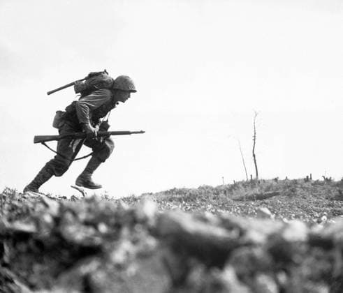 Japan USA: Marine Paul E. Ison charges across Death Valley on April 1, 1945. Battle of Okinawa The Battle of Okinawa, codenamed Operation Iceberg, was a series of battles fought in the Ryukyu Islands, centered on the island of Okinawa, and included the largest amphibious assault in the Pacific War.The 82-day-long battle lasted from 1 April until 22 June 1945.<br ><br > The Battle of Okinawa was remarkable for the ferocity of the fighting, the intensity of kamikaze attacks from the Japanese defenders, and the great number of Allied ships and armored vehicles that assaulted the island. The battle was one of the bloodiest in the Pacific. Copyright: xxPicturesxFromxHistoryx