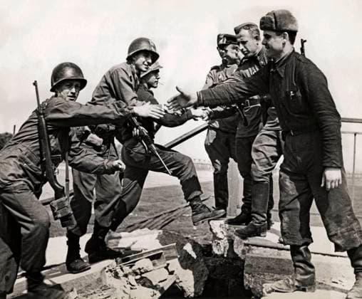 West Meets East On Elbe Bridge Torgau, Germany, April 25, 1945 American troops (left) reach out to grasp hands of soldiers of the Soviet Army on a wrecked bridge over the Elbe river after the historic link up at Torgau, Germany. Copyright: Â¬ xUnderwoodxArchives 990_05_4-WWII-Rus-USLinkUp_4HR