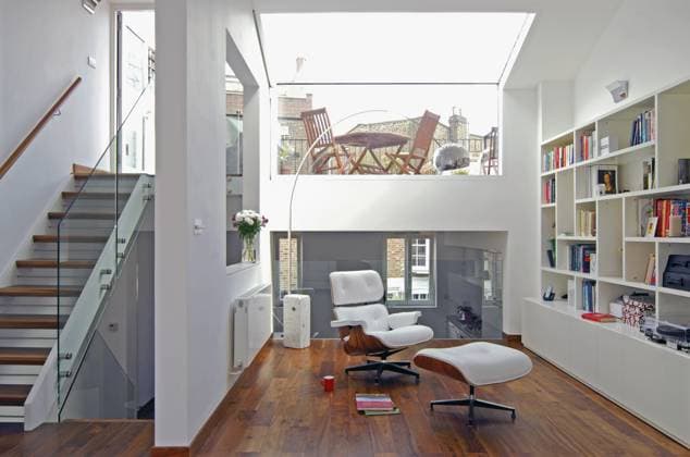 White leather Eames chair and ottoman in centre of contemporary spacious open plan room White leather Eames chair and ottoman in centre of contemporary spacious open plan room, Credit:Mark York Avalon  Copyright: xMarkxYorkx xAvalonx 0544848240
