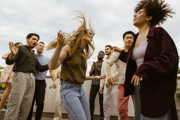 Carefree woman dancing with multiracial friends at party on rooftop deck Germany, Berlin, model released, property released Copyright: xMaskotx , MA108173 MA108173