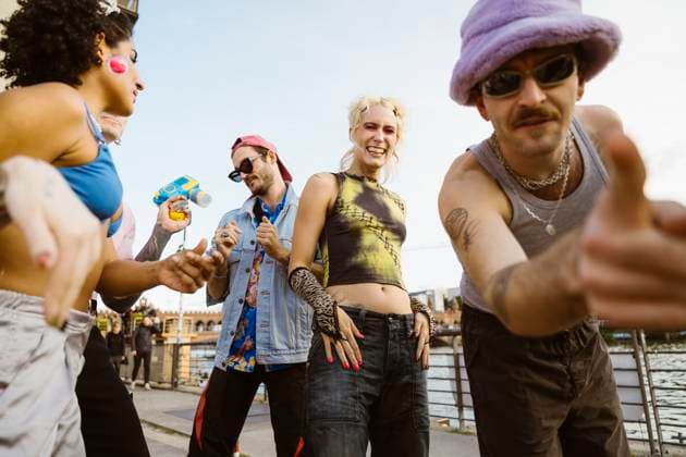 Young non-binary person dancing with friends on promenade in city Germany, Berlin, model released Copyright: xMaskotx , MA108329 MA108329
