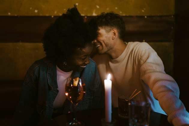 Happy multiracial couple having fun during candlelight date at bar Germany, Berlin, model released, property released Copyright: xMaskotx , MA108416 MA108416