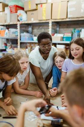 Female teacher assisting group of students working on robotics project at workshop Germany, Berlin, model released, property released Copyright: xMaskotx , MA108537 MA108537