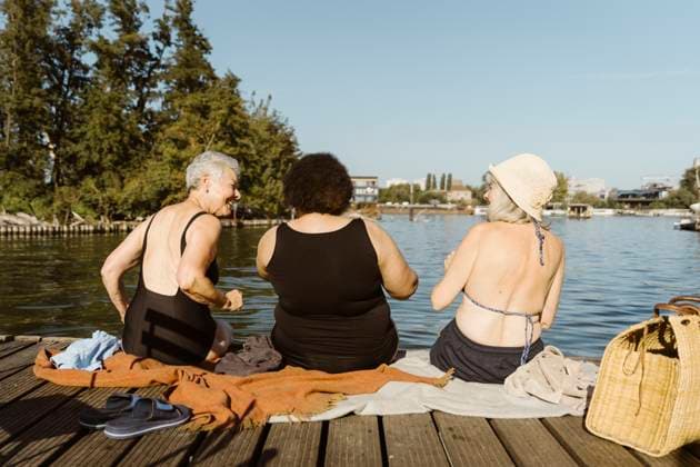 Rear view of female senior friends having fun while sitting on houseboat near lake Germany, Berlin, model released, property released Copyright: xMaskotx , MA108710 MA108710