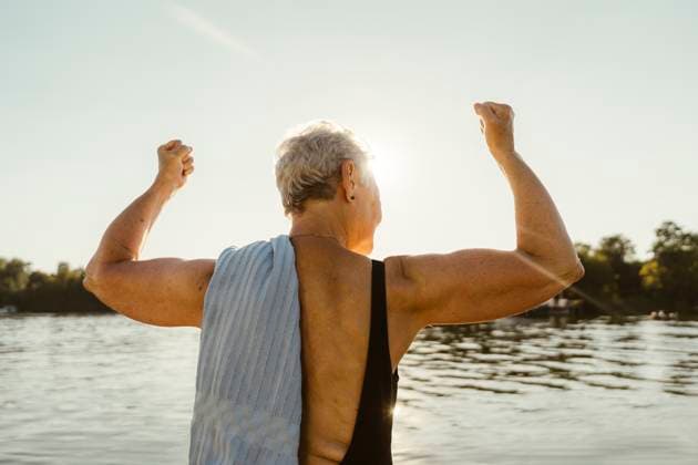 Creative Highlights Symbolbilder Rear view of senior woman flexing muscles on houseboat during vacation Germany, Berlin, model released, property released Copyright: xMaskotx , MA108719 MA108719