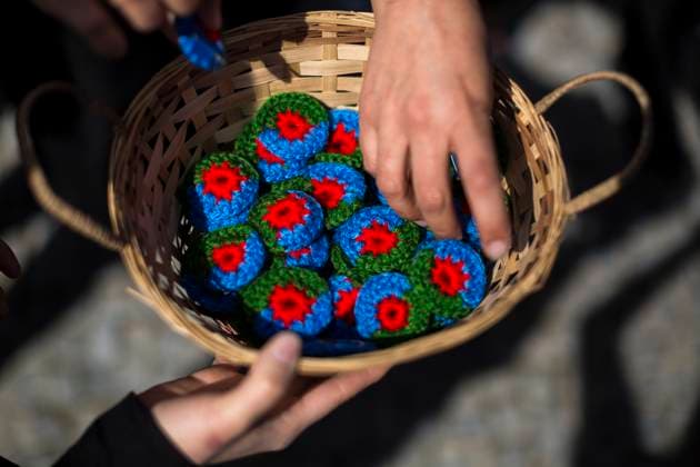 April 8, 2024, Madrid, Spain: A woman picks up woven flags of the Gypsy people, during the institutional event to celebrate the International Day of the Gypsy People, on the Segovia Bridge in Madrid. On April 8, 1971, the First World Gypsy Congress was held, a date that was institutionalized as The International Day of the Gypsy People, in addition to the creation of the gypsy flag and anthem. Madrid Spain - ZUMAs197 20240408_aaa_s197_117 Copyright: xLuisxSotox