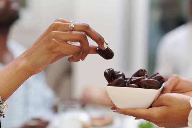 A young Muslim woman adorned in a hijab delicately takes dates, symbolizing the break of her fast in the holy month of Ramadan, encapsulating a scene of spiritual reflection, cultural tradition, and the anticipation of communal iftar A young Muslim woman adorned in a hijab delicately takes dates, symbolizing the break of her fast in the holy month of Ramadan, encapsulating a scene of spiritual reflection, cultural tradition, and the anticipation of communal iftar. ,model released, Symbolfoto Copyright: xZoonar.com BENISxARAPOVICx 21109596 ,model released, Symbolfoto ,property released