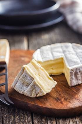 Brie type cheese with white mold. French camembert cheese on cutting board. Brie type cheese with white mold. French camembert cheese on the cutting board. Copyright: xZoonar.com JirixHERAx 21138399