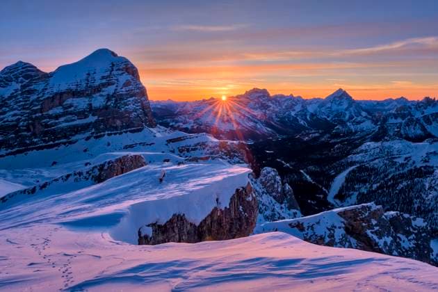 The snow-covered summit of Tofana di Rozes, surrounded by alpine Dolomite landscape around Falzarego pass in winter, seen from Mt. Lagazuoi at sunrise. Cortina d˜Ampezzo Veneto Italy FB_2024_0968