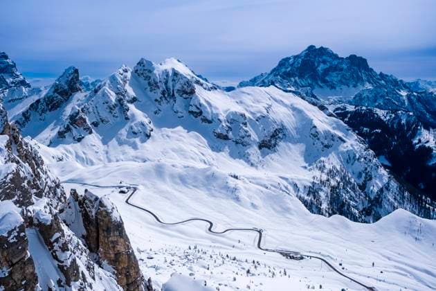 Aerial view on the snow-covered Giau pass from Mt. Nuvolau in winter, the snow-covered summits of Mt. Cernera and Mt. Civetta in the distance. Cortina d˜Ampezzo Veneto Italy FB_2024_0997