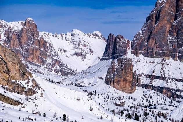 Snow-covered slopes of alpine Dolomite landscape around Giau pass in winter, the snow-covered summit of Monte Ciaval in the distance. Cortina d˜Ampezzo Veneto Italy FB_2024_1038