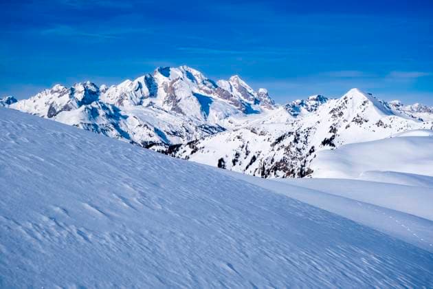 Snow-covered slopes of alpine Dolomite landscape around Giau pass in winter, the snow-covered summits of Marmolada group in the distance. Cortina d˜Ampezzo Veneto Italy FB_2024_1041