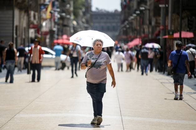 Mexiko, Rekordtemperaturen in Teilen des Landes (240417) -- MEXICO CITY, April 17, 2024 -- A woman shields herself from the sun with an umbrella in Mexico City, Mexico, on April 16, 2024. (Photo by Xinhua) MEXICO-MEXICO CITY-HEAT WAVE FranciscoxCanedo 