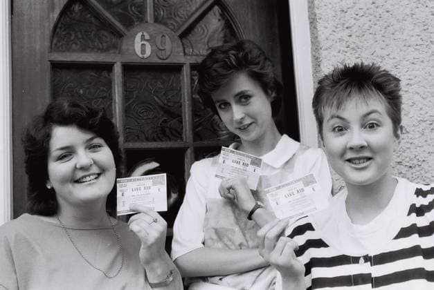 Three Female friends holds up their tickets to Live Aid, on the morning of the c Three Female friends holds up their tickets to Live Aid, on the morning of the concert,1985, Credit:Mark Charnock Avalon United Kingdom  Copyright: xMarkxCharnockx xAvalonx 0531870813