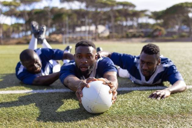 Creative Highlights Symbolbilder Three African American young male athletes reaching for a rugby ball on a grass field Three African American young male athletes reaching for a rugby ball on a grass field. All wearing blue jerseys, showing focus and teamwork during training, unaltered., model released, , property released, Cape Town, South Africa, 2024-03-27T22:00:00.000Z, 5221730.jpg, people,three,African American,young male,athlete,reaching,rugby ball,grass field,wearing,blue,jersey,showing,focus,teamwork,training,unaltered,fitness,workout,exercise,fit,athletic,sport,team,active,gym,sportswear,strength,activity,muscular,runner,body,sporty,attractive person,solo artist practicing,acoustic live,sky,hands fingers,soloist player performing,meeting,strong,instruments perform
