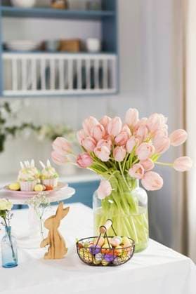 Easter decorations and peach color tulips on table at home property released, ONAF00726