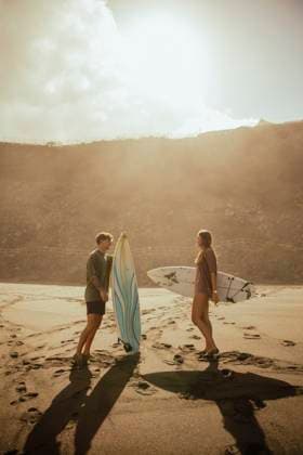 Couple with surfboards talking at beach on sunny day model released, Symbolfoto, ACPF01588