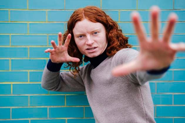 Creative Highlights Symbolbilder Redhead man showing palms and gesturing near tile wall model released, Symbolfoto, ASGF05073