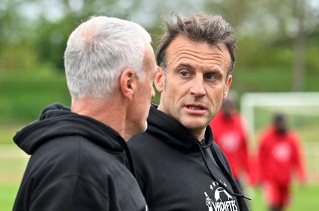 Macron Takes Part In Charity Football Match - Plaisir President Emmanuel Macron flanked by France s head coach Didier Deschamps walk on the pitch prior to the Varietes Club charity football match to benefit children in hospital, in Bernard Giroux stadium, in Plaisir, outside Paris, France on April 24, 2024. Photo by Eric Tschaen Pool ABACAPRESS.COM Plaisir IDF France  Copyright: xTschaenxEric Pool ABACAx