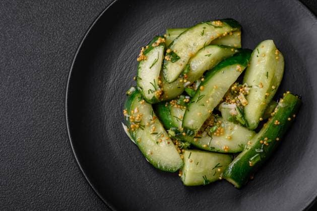 IMAGO Creative, Food, Gurkensalat Delicious juicy cucumber cut into large slices with salt, spices and french mustard Delicious juicy cucumber cut into large slices with salt, spices and french mustard on a dark concrete background Copyright: xZoonar.com TetianaxChernykovax 21469625
