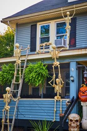 Halloween decorations on exterior of home with skeletons climbing up to roof Image of Halloween decorations on exterior of home with skeletons climbing up to roof Copyright: x RECORD DATE NOT STATED