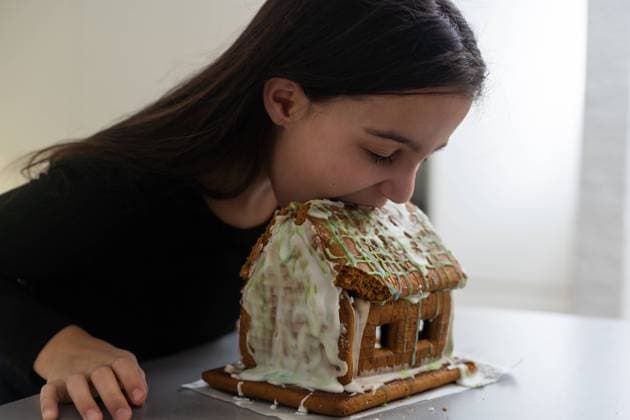 Kids with gingerbread house, A teenage girl is eating a gingerbread house Kids with gingerbread house, A teenage girl is eating a gingerbread house. Copyright: xsinenkiy RECORD DATE NOT STATED
