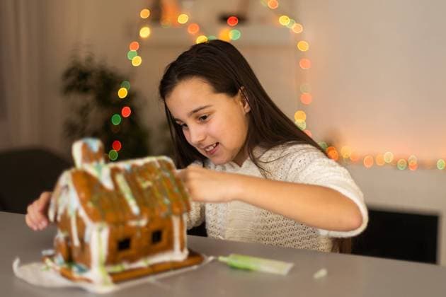 Cute little girl with gingerbread spooky house with festive icing and ghost shaped cookie. Happy Halloween Cute little girl with gingerbread spooky house with festive icing and ghost shaped cookie. Happy Halloween. Copyright: xsinenkiy RECORD DATE NOT STATED